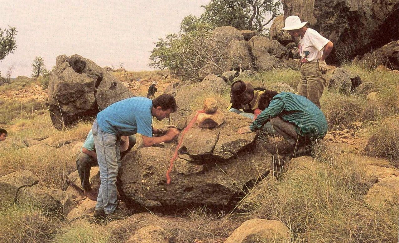 Riversleigh team members examining a newly discovered fossil deposit