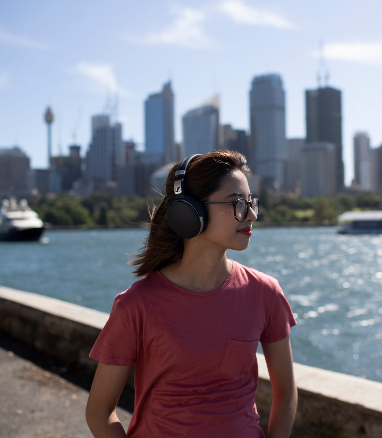 Female student walking in front of Sydney harbour skyline