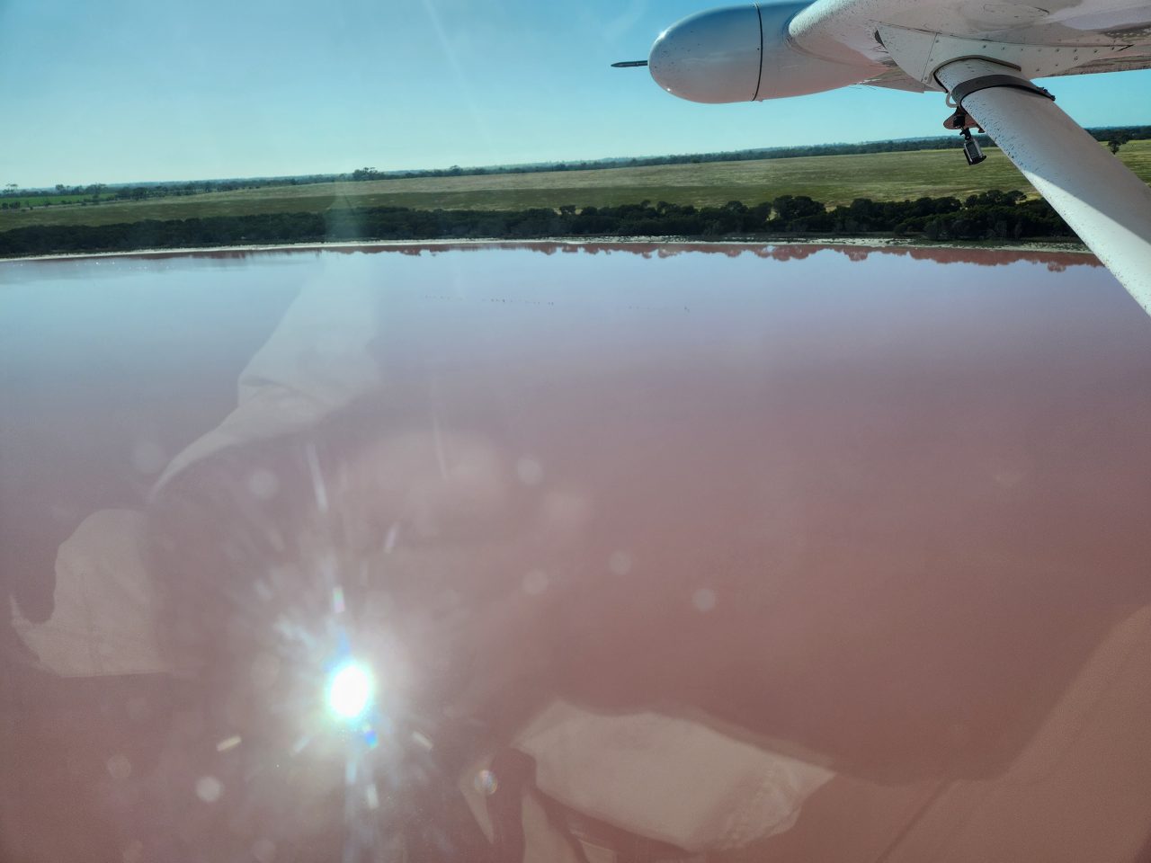 Inland lake with pink water caused by bacteria