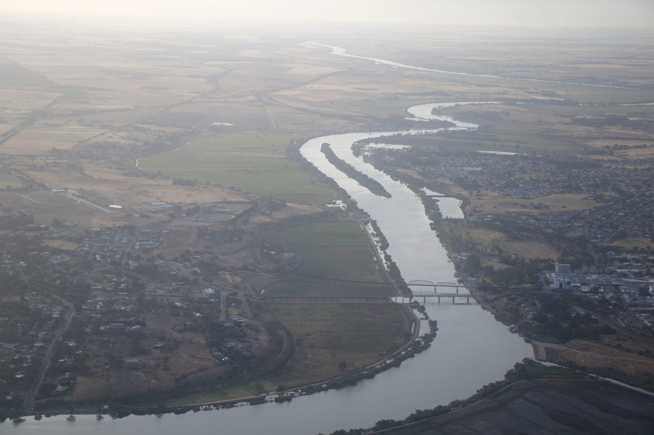 Large river channel and floodplain, bridge crossing river between built up areas