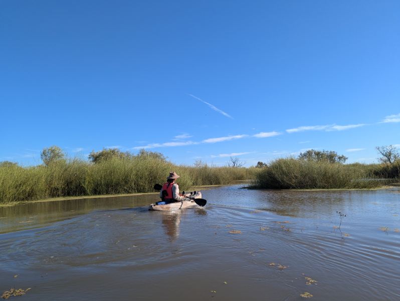A person on a lagoon in a canoe