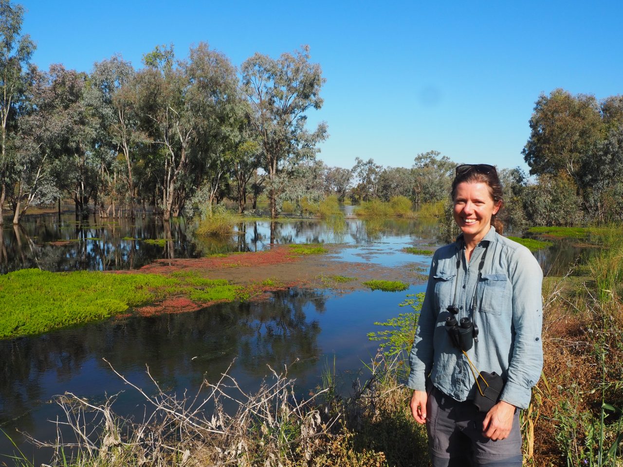 Dr Celine Steinfeld standing nest to a flooded wetland in the Macquarie Marshes 2022