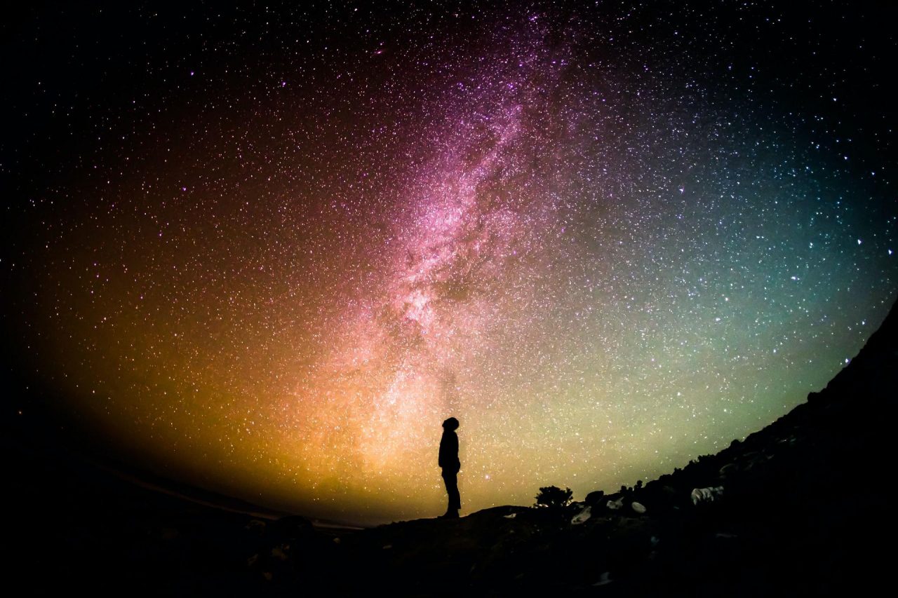 Silhouette of person looking up at the Milky Way