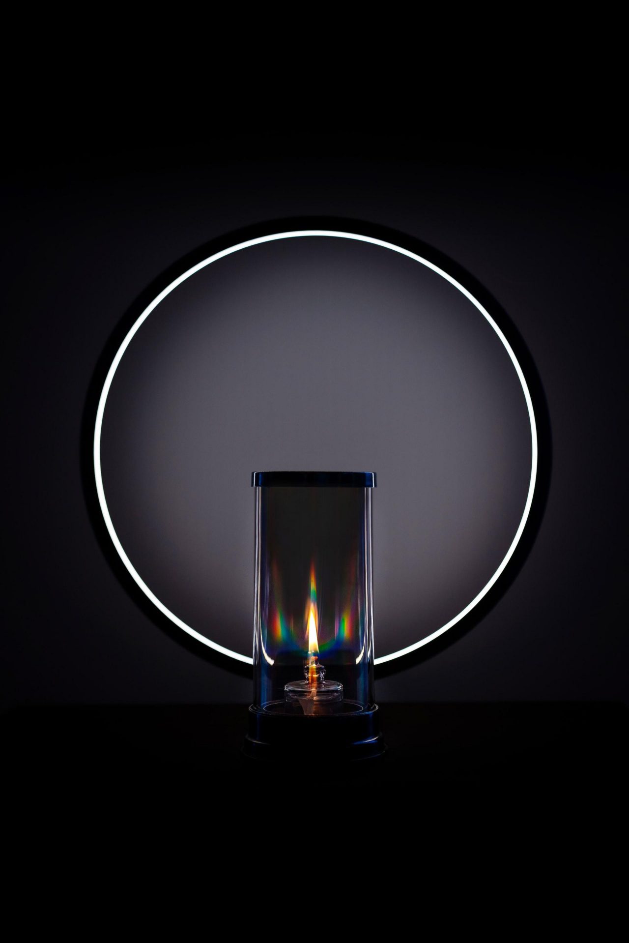 Prismatic oil lamp in front of a modern circular lamp