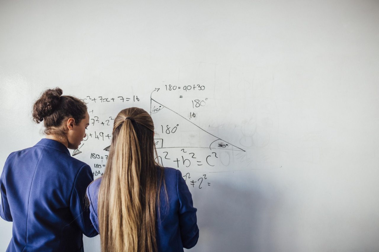 Girls doing maths on whiteboard
