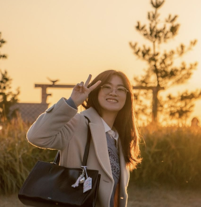 A person smiling during sunset in Japan