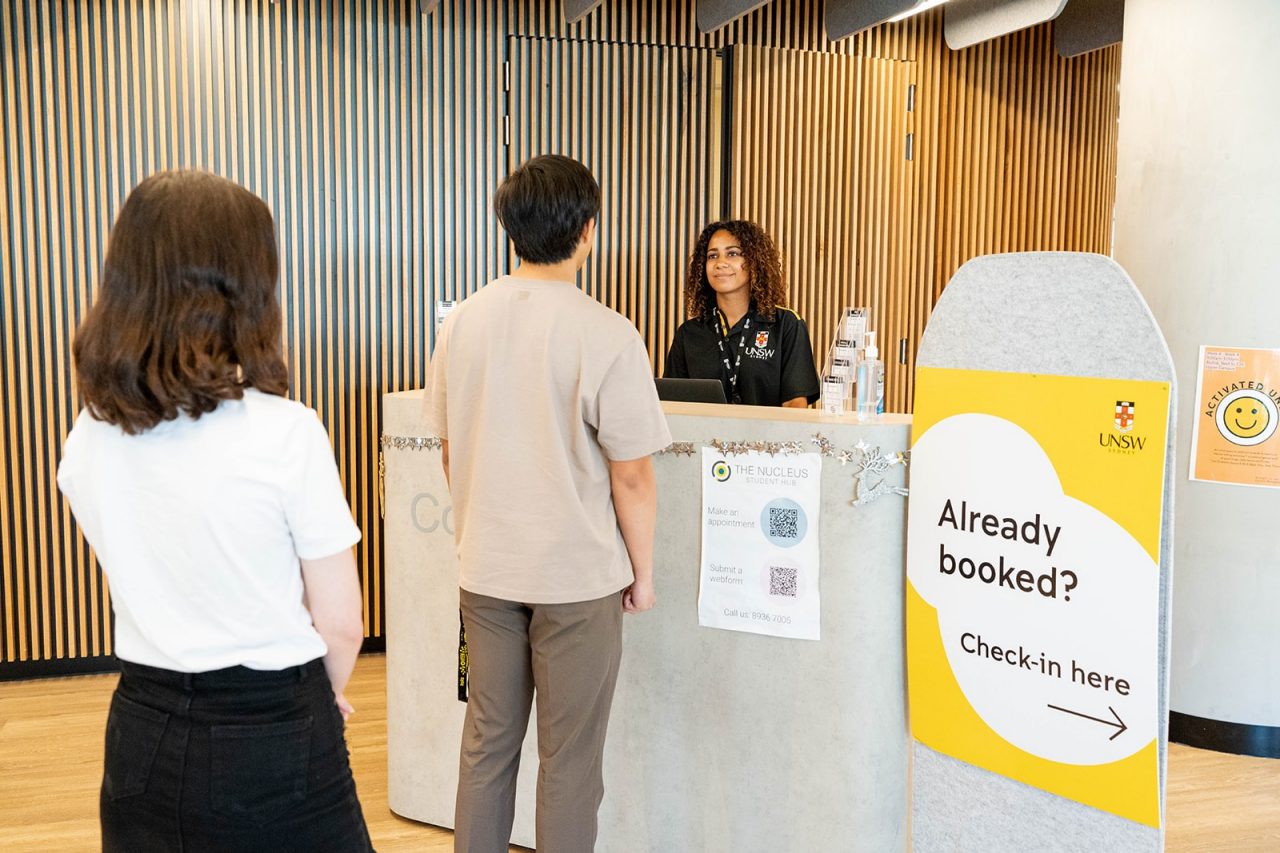 Student speaking with a staff member at The Nucleus: Student Hub